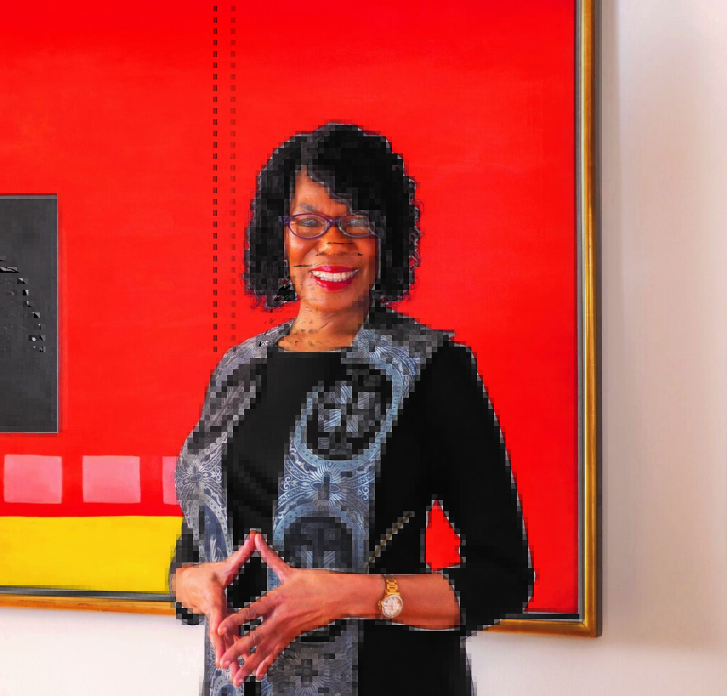 Rev. Dr. Debra Haggins in front of Georgia O'Keefe painting