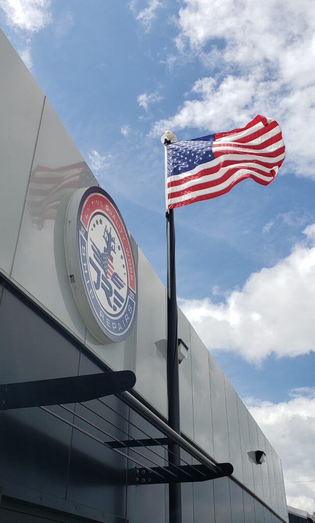 American flag flying outside JRF Ship Repair